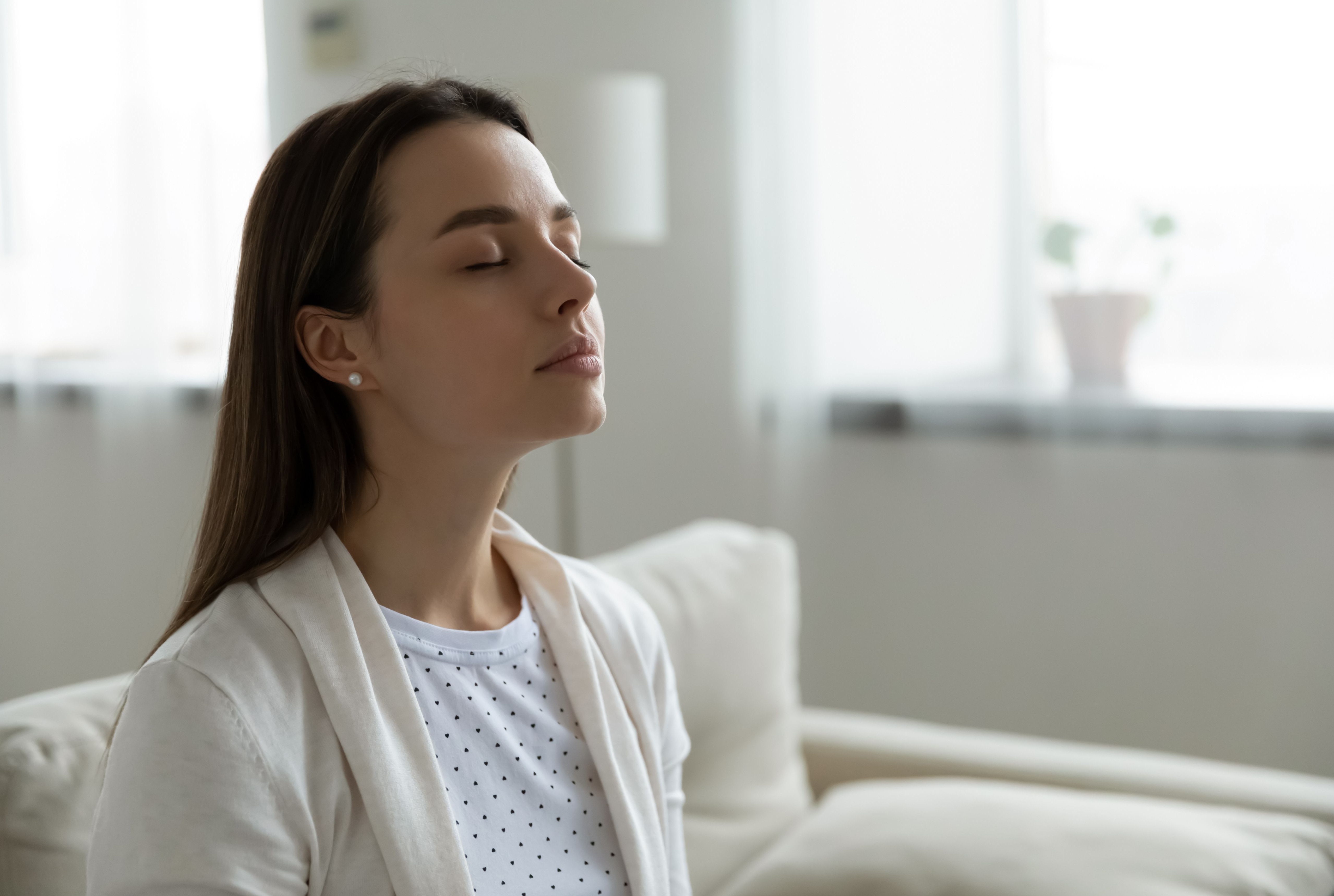 Person sitting on a couch with eyes closed